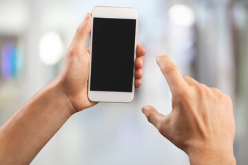 Human hand hold a phone with a blank screen