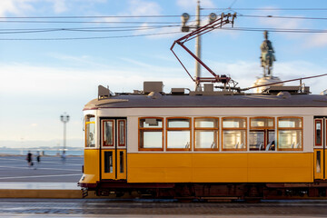 Panning photography of old vintage and famous tram on the rail on street, The little yellow...