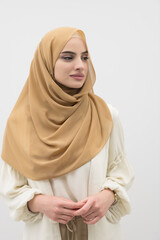 Portrait of young muslim woman wearing hijab on isolated white background