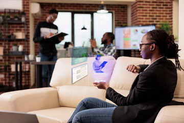 Businesswoman talking to person on ai hologram, using augmented reality and artificial...