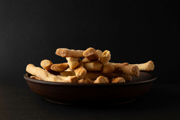 Cookies in a plate on a black background.