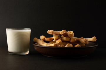Cookies and milk on a dark background.