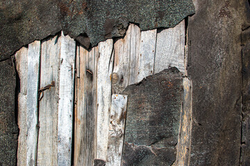 Grunge background: old gray colored metal and weathered plank wood with rusted metal nails