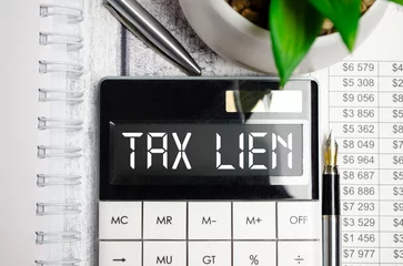 Foto op Aluminium TAX LIEN. white background text on calculator display © Andrey