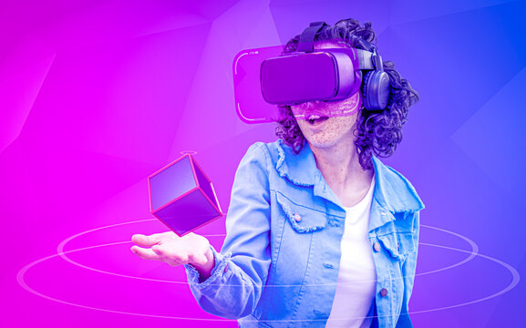 Amazed young woman with hologram 3d cube in hand using virtual reality world connected in metaverse with VR glasses