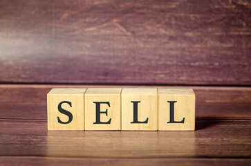 sell word on wooden blocks on wooden background