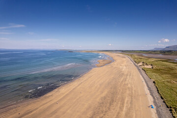 Aerial view on Streedagh beach in county Sligo, Ireland. Beautiful nature scene with warm yellow sand and blue ocean and clear blue sky. Popular tourist area. Warm sunny day.