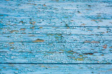 Wooden surface with cracked blue paint