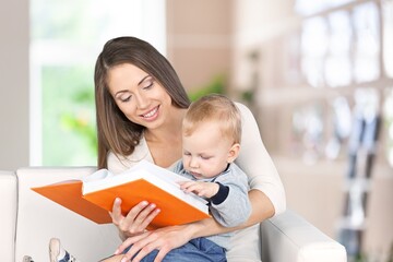 A young mother reads a book for her small child
