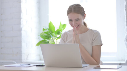 Woman Celebrating Online Success on Laptop in Office