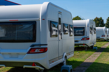 A row of touring caravans on standing on a sunny day in summer.