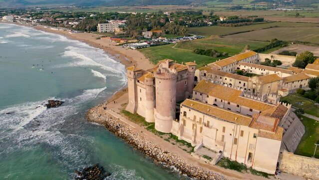 Flying around Santa Severa Castle, with the Beach fading in the distance - slow motion waves 60fps - beautiful fortress by the Tyrrhenian Sea near Rome, Italy - Santa Marinella