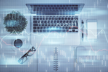 Multi exposure of forex chart drawing over table background with computer. Concept of financial research and analysis. Top view.
