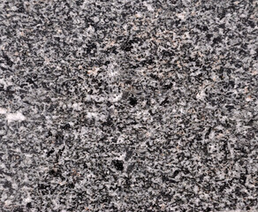 Textura de pedra mármore com cores pretas, cinzentas e brancas, manchas irregulares