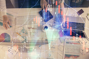 Multi exposure of man and woman working together and financial chart hologram. Business concept. Computer background.