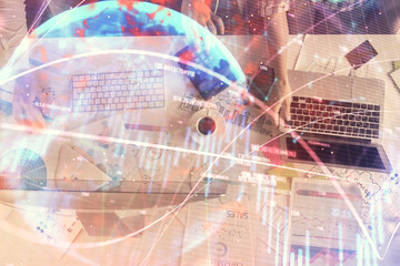 Multi exposure of man and woman working together and financial chart hologram. Business concept. Computer background.