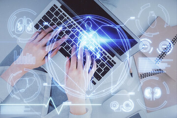 Double exposure of woman hands working on computer and education theme hologram drawing. Top View. Science concept.