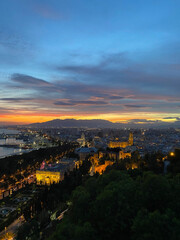 Fototapeta premium evening view of Malaga City and harbor from Castillo de Gibralfaro, Andalusia, Spain. High quality photo