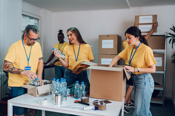 Group of multiracial volunteers working in community charity donation center