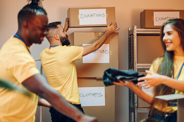 Group of multiracial volunteers working in community charity donation center