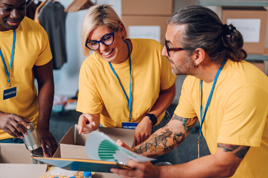 Group of multiracial volunteers working in community charity donation center
