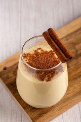 Eggnog cup with cinnamon powder.