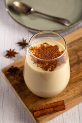 Eggnog cup with cinnamon powder.