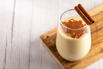 Eggnog cup with cinnamon powder.
