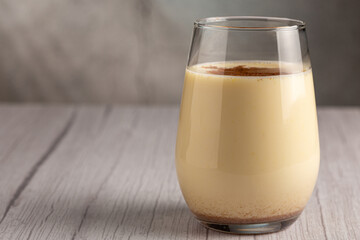 Eggnog cup with cinnamon powder.