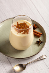 Eggnog cup with cinnamon powder.