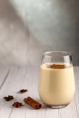 Eggnog cup with cinnamon powder.