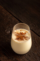Eggnog cup with cinnamon powder.