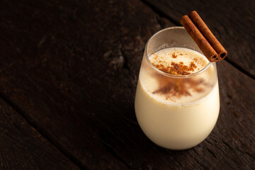 Eggnog cup with cinnamon powder.