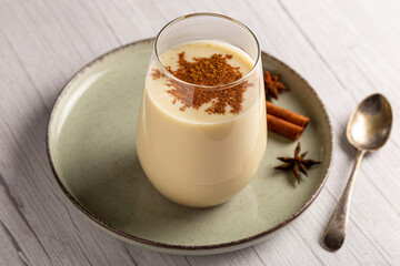 Eggnog cup with cinnamon powder.