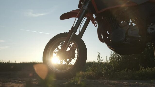 motorcycle front wheel stops at sunset slow motion