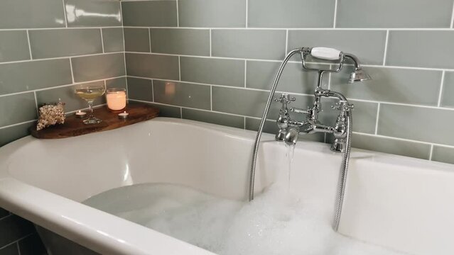 Run a bath. Modern bath with equipment of aromatherapy at home, interior design decoration. Relaxation time. 