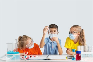 Teen school children doing experiment in laboratory