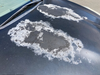 Old car bonnet engine hood gray with paint faded grunge damaged by sun and time