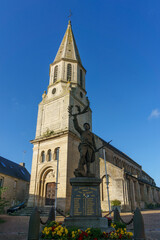 Fototapeta na wymiar typical scene in small french town with a memorial of the World War 1 and 2 and church in the background, Creully sur Seulles, Normandy, France