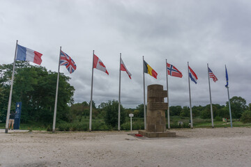 Memorial of battle on D-Day at the Pegasus Bridge between british and german soldiers with flags,...