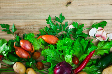 Ingredients for vegetarian dishes. Fresh raw vegetables, herbs and seasonings on wooden surface