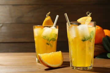 Delicious orange soda water on wooden table