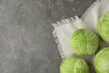Ripe white cabbage on grey table, flat lay. Space for text