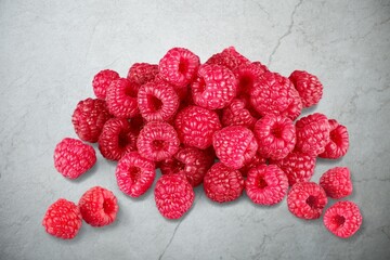 Fresh ripe juicy raspberries berry on kitchen desk.