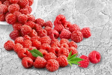 Fresh ripe juicy raspberries berry on kitchen desk.