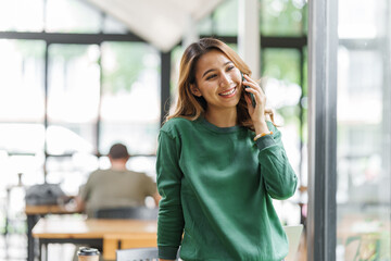 Successful asian woman entrepreneurs using mobile start up grow their businesses with mobile, application and technology concept.