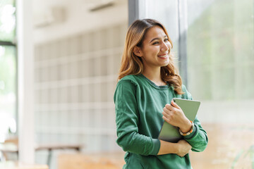 Successful asian woman entrepreneurs using tablet start up grow their businesses with laptop and technology concept.