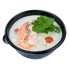 tom kha soup with shrimps, mushrooms and tomatoes on black bowl isolated on white background