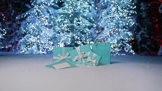 Snowflakes slowly falling at shiny silver Christmas trees sparkling lights in blurry background. Magic night, Happy New Year 2023 with snowfall over elegant blue gift boxes with white ribbon footage