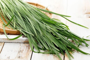 Close Up Kucai or Chives on Wooden Table - obrazy, fototapety, plakaty